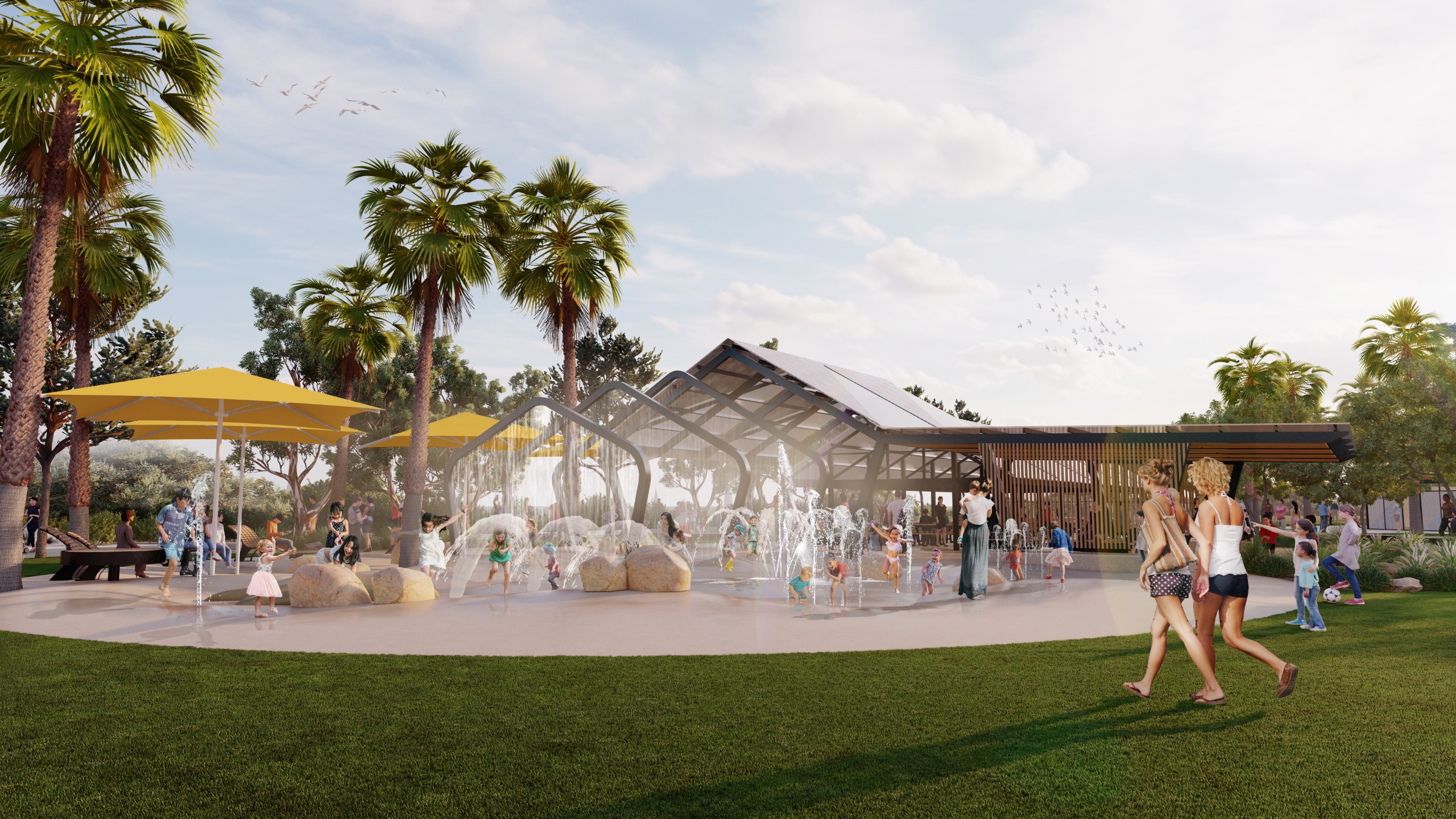 Open area with children playing under water play elements including a water curtain