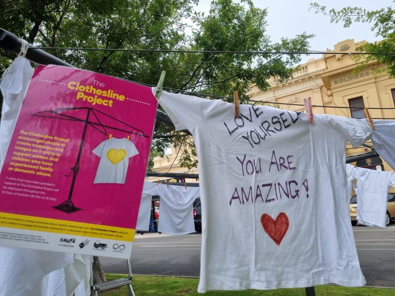 Clothesline of anti-domestic violence art on shirts